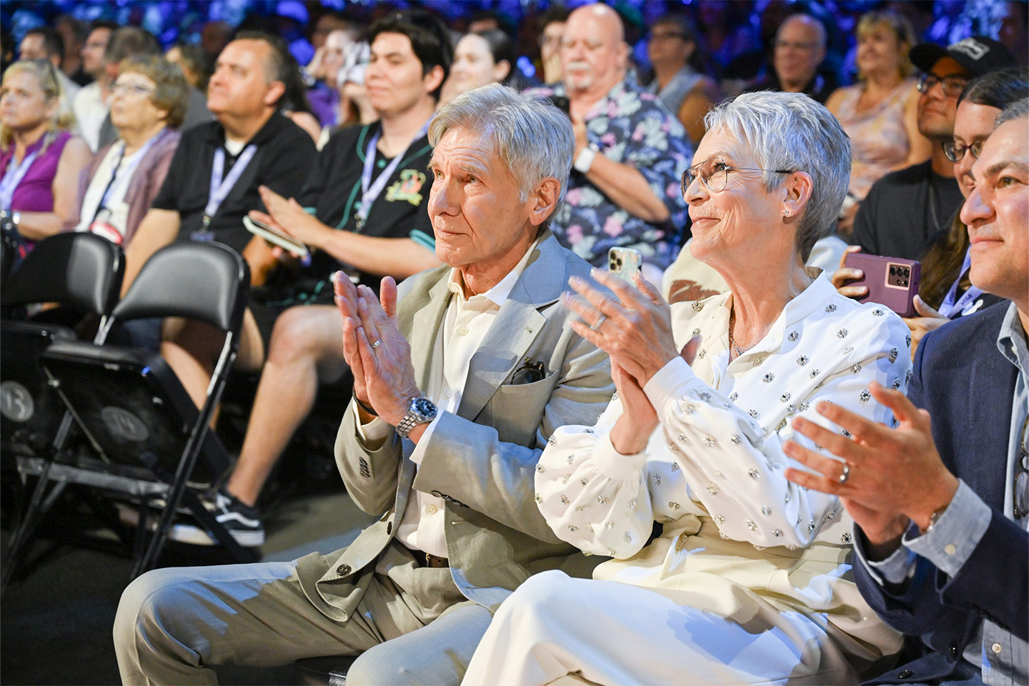 Disney Legends Harrison Ford and Jamie Lee Curtis look upwards towards the Disney Legends awards ceremony stage.