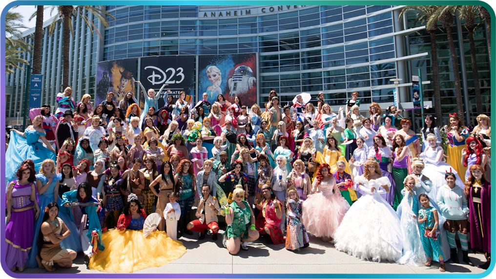 A group of cosplaying fans gathered in front of the Anaheim Convention Center cheer in excitement for D23.